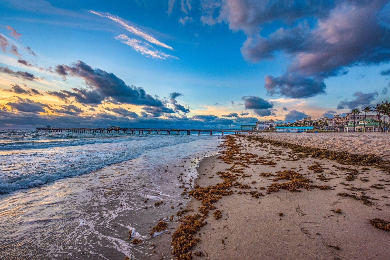 Anglin's Fishing Pier stretching over the Atlantic at sunset, Lauderdale-by-the-Sea beach in the foreground