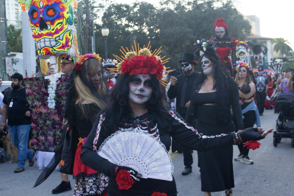 Costumed Catrinas and giant puppets in the Fort Lauderdale Day of the Dead stroll